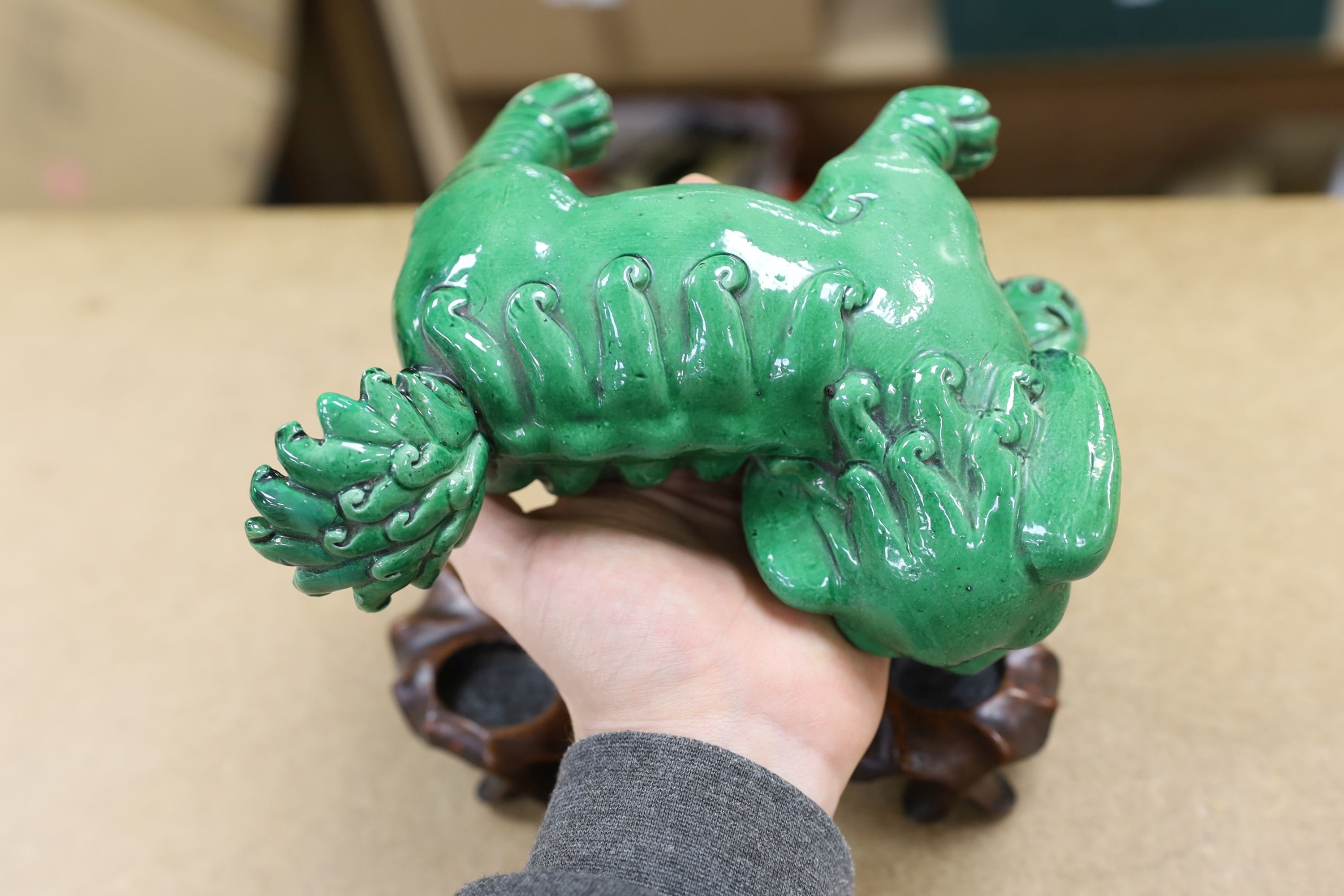 A 19th century Chinese green glazed model of a lion-dog, and two green crackle glaze jars, tallest 16cm